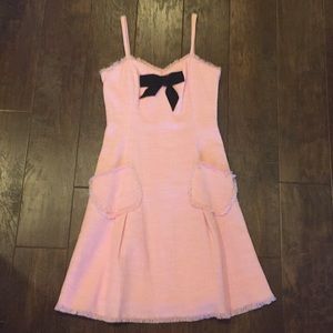 Pink dress with black bow and pockets